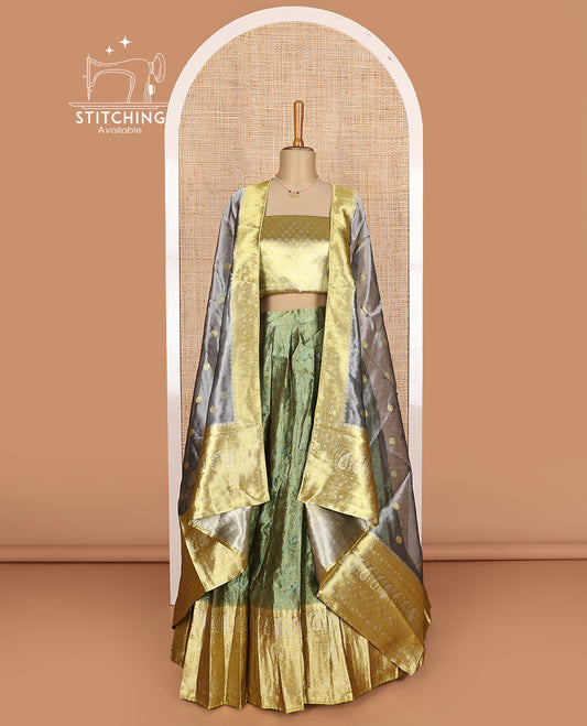 Green art silk half-saree, sparsely design with contrast traditional motifs bordered skirt, contrast blouse, and traditional motif dhavani
