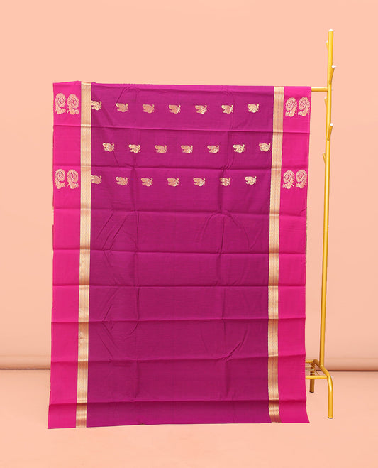 Rani Pink Semi-Silk Cotton Saree, Artfully Designed with Peacock Zari Buttas on Its Body, Complemented by a Contrast Border of Peacock Designs, Pallu Steeped with Peacock Zari Design, and Paired with a Matching Blouse