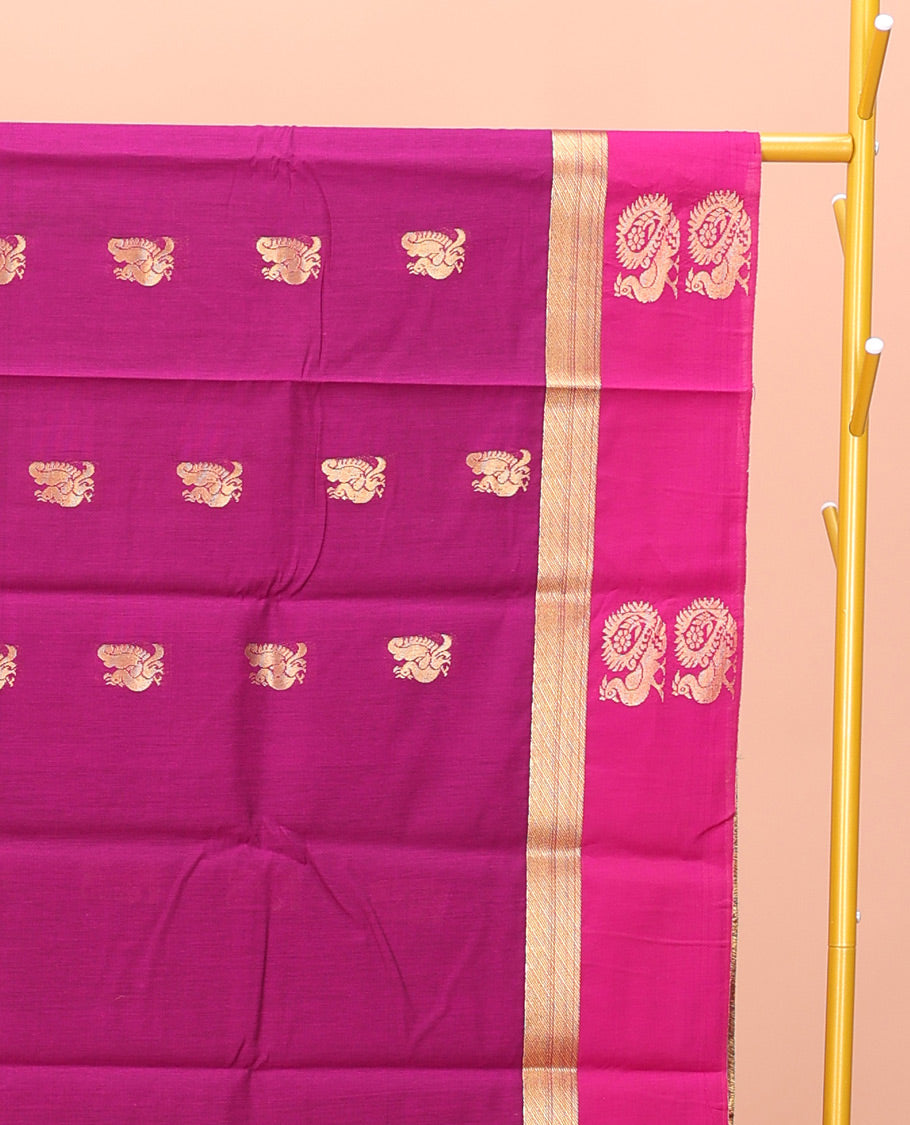 Rani Pink Semi-Silk Cotton Saree, Artfully Designed with Peacock Zari Buttas on Its Body, Complemented by a Contrast Border of Peacock Designs, Pallu Steeped with Peacock Zari Design, and Paired with a Matching Blouse