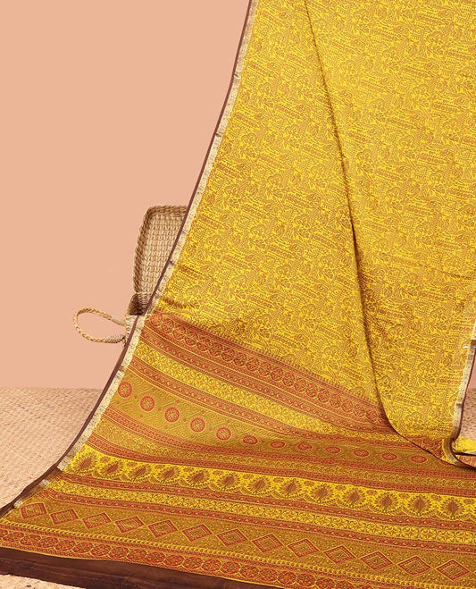 Yellow intricately printed semi-banaras printed saree, contrast zari border & intricate pallu 