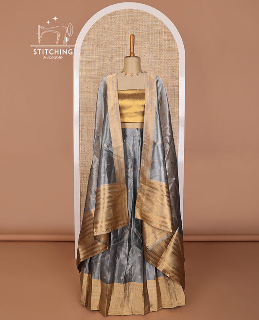 Grey buttas tissue half saree with  contrast striped border, zari design blouse & floral design dhavani