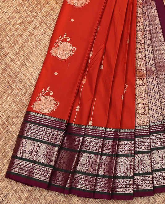 Orange Budget Silk Saree, Subtly Enriched with Zari Buttas on Its Body, Complemented by a Contrast Traditional Zari Designs Woven Border, Grand Pallu of Buttas and Stripes, and Paired with a Contrast Blouse