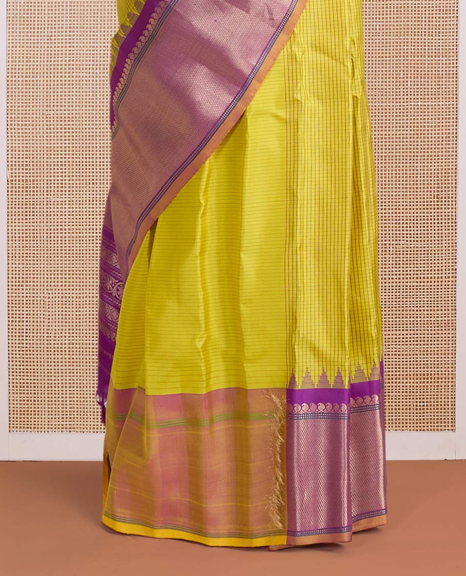 Yellow micro-checked & zari buttas gadwal silk saree, contrast temple zari border & pallu steeped with traditional designs