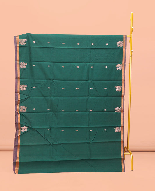 Bottle Green Semi-Silk Cotton Saree, Impeccably Designed with Peacock Zari Buttas on Its Body, Complemented by a Contrast Border of Peacock Designs, Pallu Steeped with Peacock Zari Design, and Paired with a Matching Blouse