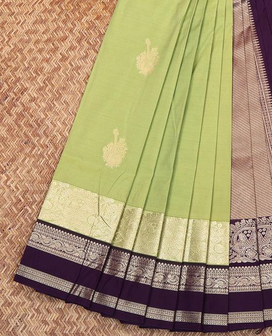 Green Budget Silk Saree, Elegantly Highlighted with Zari Buttas on Its Body, Complemented by a Contrast Traditional Zari Designs Woven Rettai Pettu Border, Grand Pallu of Diagonal Stripes, and Paired with a Contrast Blouse