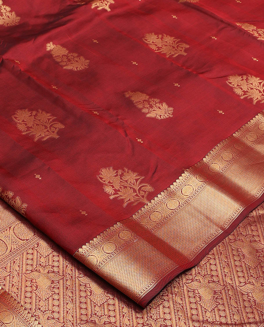 Maroon zari buttas Vasundhara silk mix saree, zari border of thilakam mokku, kodi viisry, and mayil kann, and pallu of iruthalai pakshi and geometric pattrens