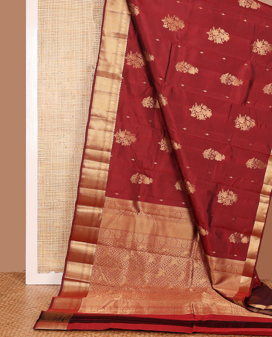 Maroon zari buttas Vasundhara silk mix saree, zari border of thilakam mokku, kodi viisry, and mayil kann, and pallu of iruthalai pakshi and geometric pattrens