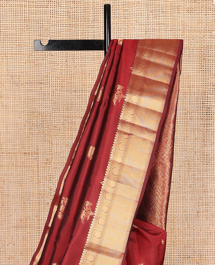 Maroon zari buttas Vasundhara silk mix saree, zari border of thilakam mokku, kodi viisry, and mayil kann, and pallu of iruthalai pakshi and geometric pattrens