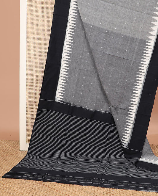 Grey Ikkat Cotton Saree Sparsely Sparkled with Small Buttas All Over Its Body, Complemented by a Contrast Temple Border, and Pallu Steeped with Stripes