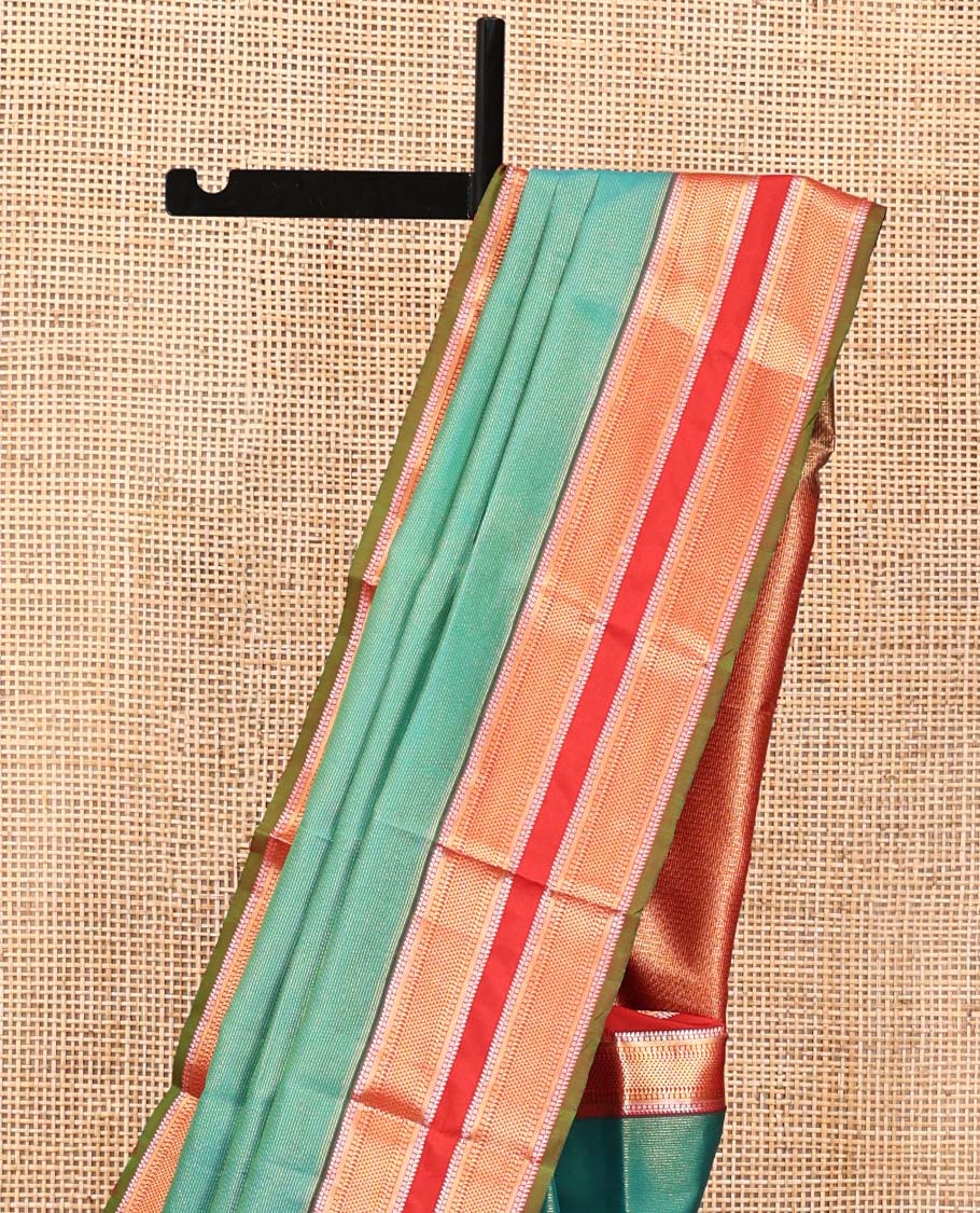 Green Vasundhara Lite Silk Saree, Gleamed up with Zari Vaira Oosi Stripes All Over Its Body, Complemented by Contrast Rettai Pettu Border of Ara Maadam Designs, Grand Pallu and Paired with a Contrast Blouse