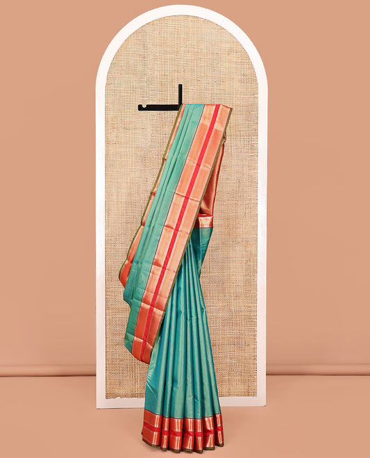 Green Vasundhara Lite Silk Saree, Gleamed up with Zari Vaira Oosi Stripes All Over Its Body, Complemented by Contrast Rettai Pettu Border of Ara Maadam Designs, Grand Pallu and Paired with a Contrast Blouse