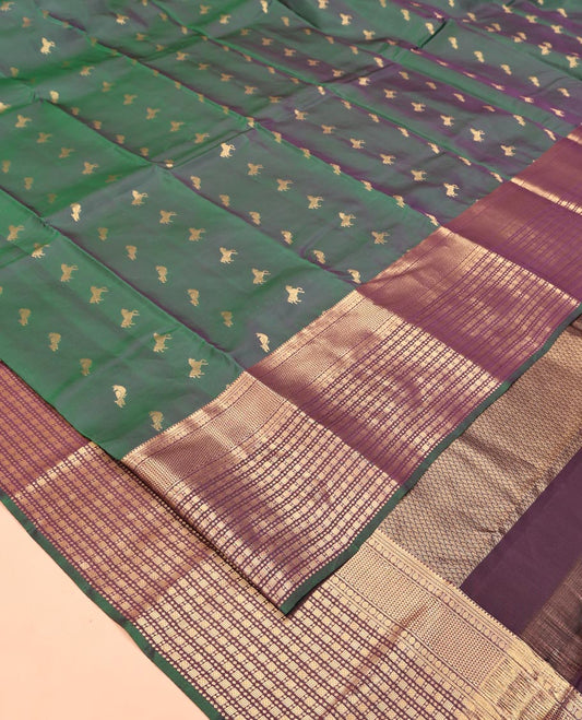 Green Vasundhara Lite Silk Saree, Enriched with Zari Buttas All Over Its Body, Complemented by Contrast Border of Rekku, Poun, Ara Maadam, and Geometric Patterns, Grand Pallu and Paired with a Contrast Blouse