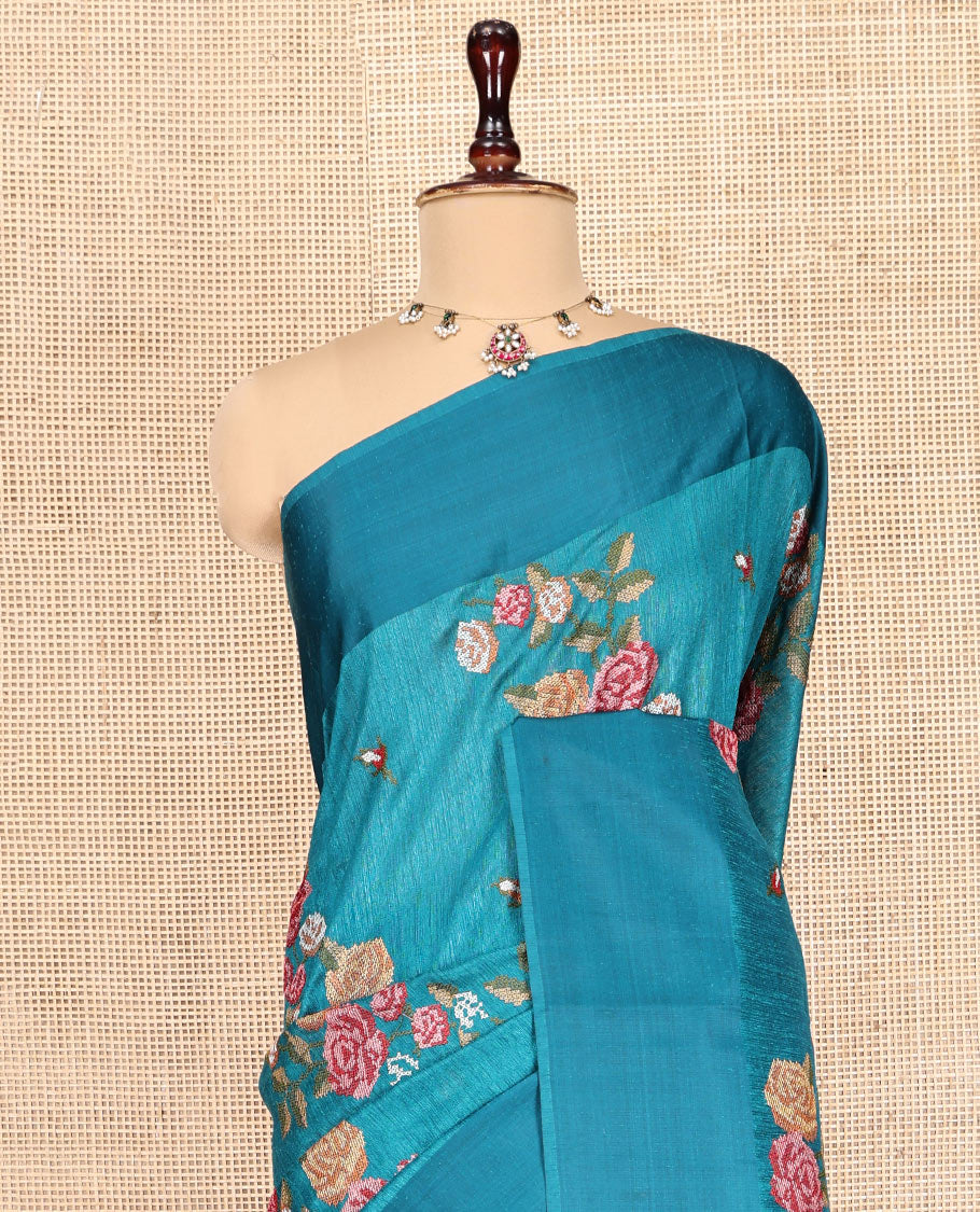Rama Blue Green-Silk Saree, Colorfully Highlighted with Rose Motifs Cross Stitch Embroidery on Its Body, Subtly Sparkled by a Plain Border, Pallu of Rose Cross Stitch Embroidery, and Paired with a Contrast Blouse