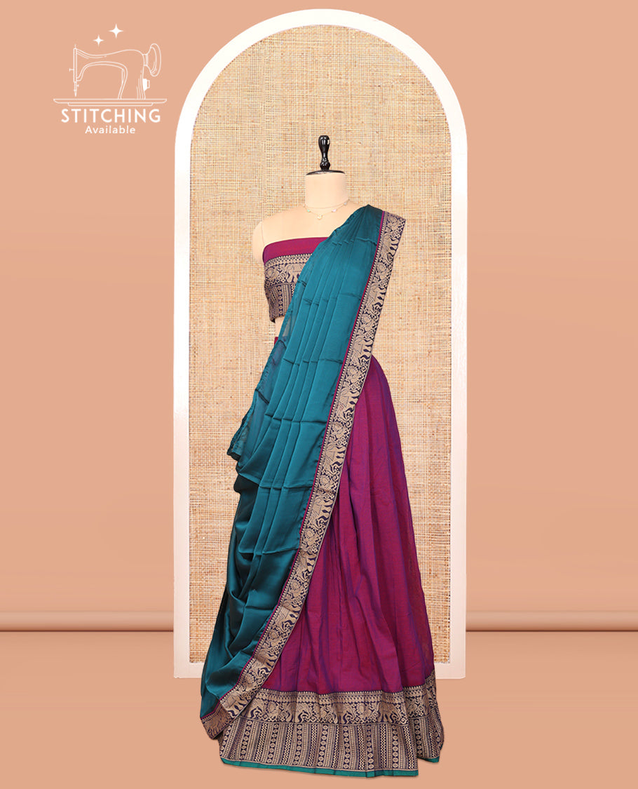 Purple Cotton Half-Saree Features Plain Skirt, a Contrast Traditional Thread Border, a Matching Blouse, and a Contrast Dhavani