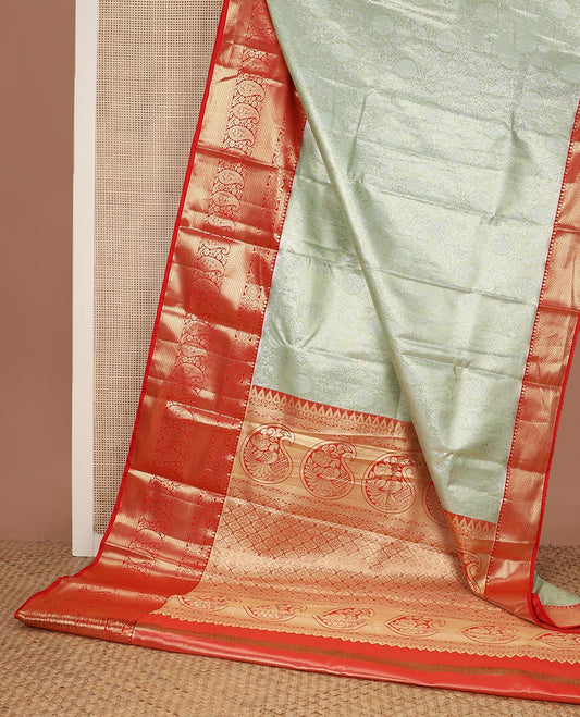 Pastel green floral jaal jacquard budget silk saree, contrast big traditional zari design border, and ogee patterned pallu