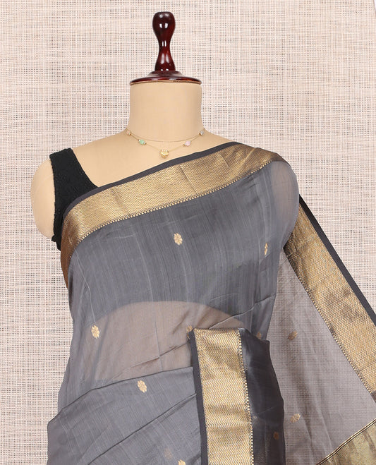 Grey Maheshwari Cotton Saree, Embellished with Buttas, Highlighted by a Traditional Zari Border, Pallu Gleamed Up with Zari Buttas, and a Contrast Blouse