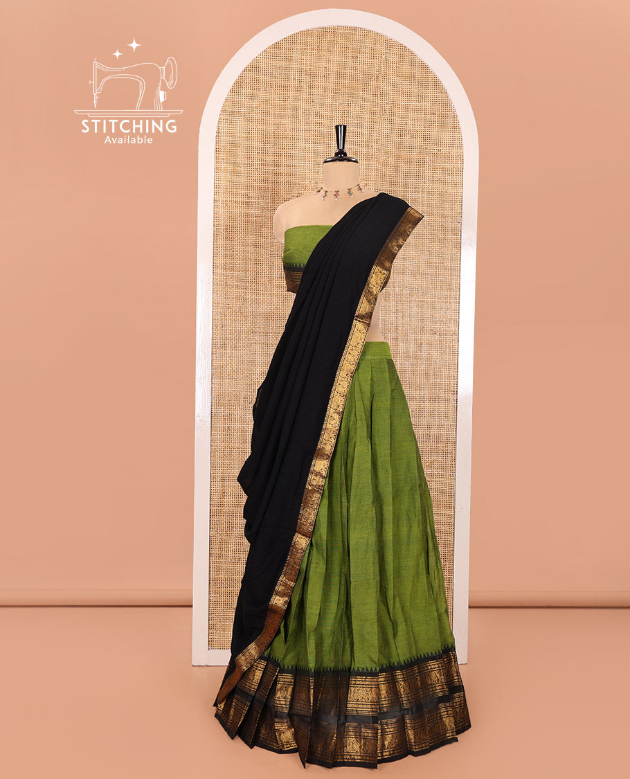 Green and Black Chettinad Cotton Half-Saree Featuring Plain Skirt, Complemented by Contrast Rettai Pettu Traditional Border of Peacock and Elephant Designs, Paired with a Matching Blouse, and a Satin Georgette Zari Bordered Dhavani