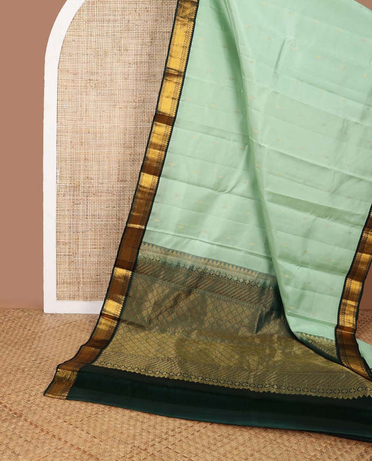 Light blue floral buttas silk saree with contrast border of thilakam mokku, manga, muthu, vanki design & zari design border