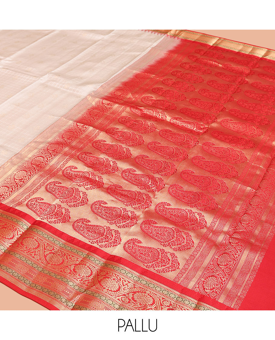 Cream Vasundhara Silk Saree, Subtly Sparkled with Buttas And Checks On Its Body, Complemented by Captivating Contrast Border of Thazampoo Rekku, Muthu, Banaras, and Kodi Visiry Designs, Pallu Steeped with Manga Designs, And Paired with a Contrast Blouse