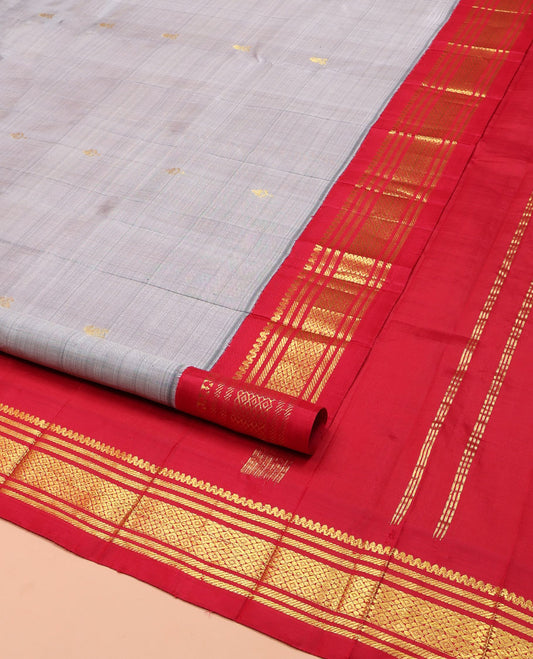 Grey Kanchipuram Silk Saree, Subtly Sparkled with Zari Buttas on Its Body, Complemented by a Contrast One-Sided Korvai Border of Salngai, Banaras, and Jaal Designs, Pallu Features Zari Designs, and Comes Without a Blouse