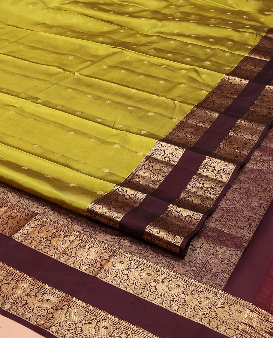 Green Vasundhara Lite Silk Mix Saree, Finely Crafted with Zari Buttas on Its Body, Complemented by Contrast Rettai Pettu Border of Mayil and Laddu Kamalam Designs, Pallu Mirrors the Same Designs, and Paired with a Contrast Blouse