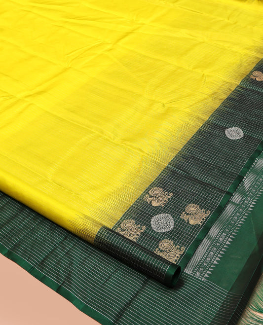 Yellow Kanchipuram Silk Saree, Sparsely Woven with Vaira Oosi Stripes, Complemented by a Contrast Checked Mayil-Chakram Border, Vanki Pallu, and a Contrast Blouse