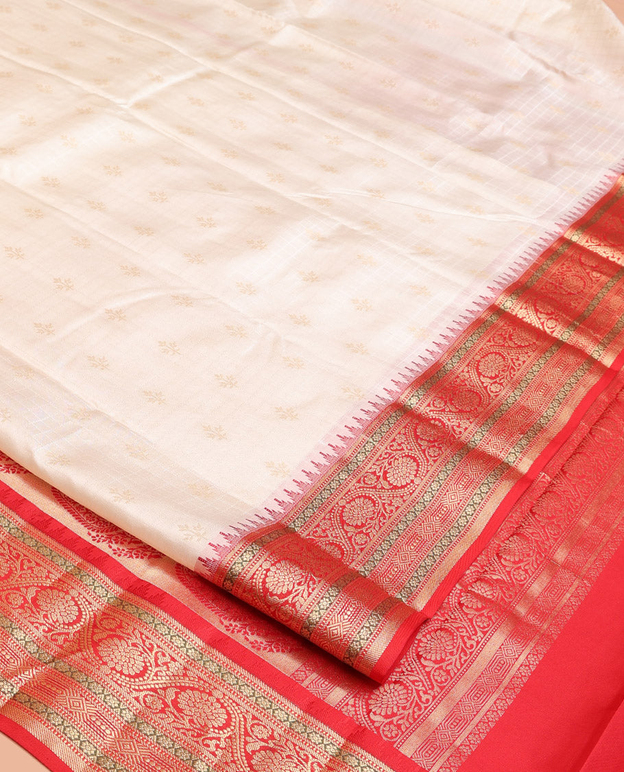Cream Vasundhara Silk Saree, Subtly Sparkled with Buttas And Checks On Its Body, Complemented by Captivating Contrast Border of Thazampoo Rekku, Muthu, Banaras, and Kodi Visiry Designs, Pallu Steeped with Manga Designs, And Paired with a Contrast Blouse
