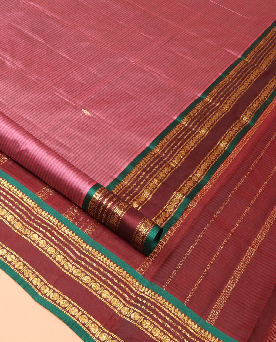 Rosewood Pink Kanchipuram Silk Saree Adorned with Vazhaipoo Stripes and Zari Buttas, Complemented by a Contrast Rettai Pettu Border Featuring Thazampoo Rekku, Muthu, Neli, and Rudraksham Designs, Gleaming Zari Pallu, and Paired with a Contrast Blouse