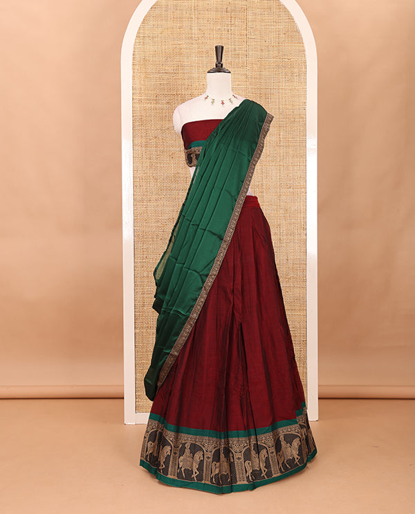Maroon with green mercedised cotton half-saree, contrast elephant zari border skirt, matching blouse & one side border georgette dhavani