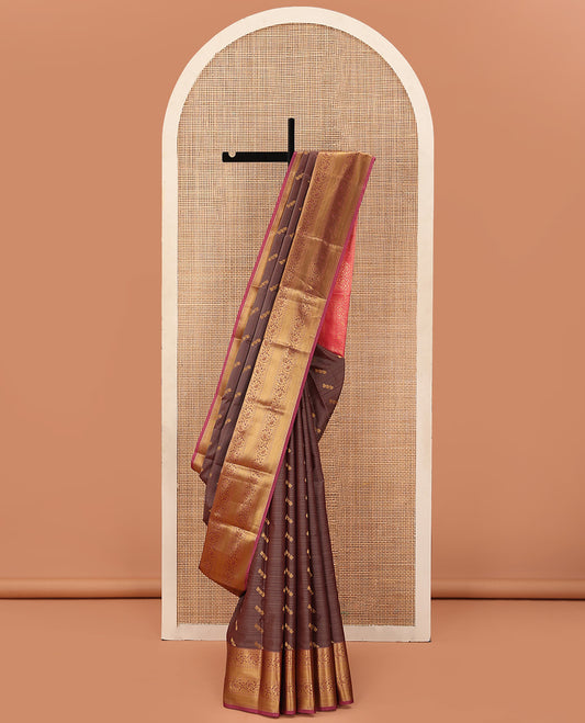 Brown Vasundhara Lite Silk Mix Saree Artfully Detailed with Zari Buttas, Complemented with a Contrast Border Featuring Ara Bogudi, Kathir, Muthu, and Kodi Visiry Designs, Pallu Decked Up with Traditional Designs, and a Contrast Blouse