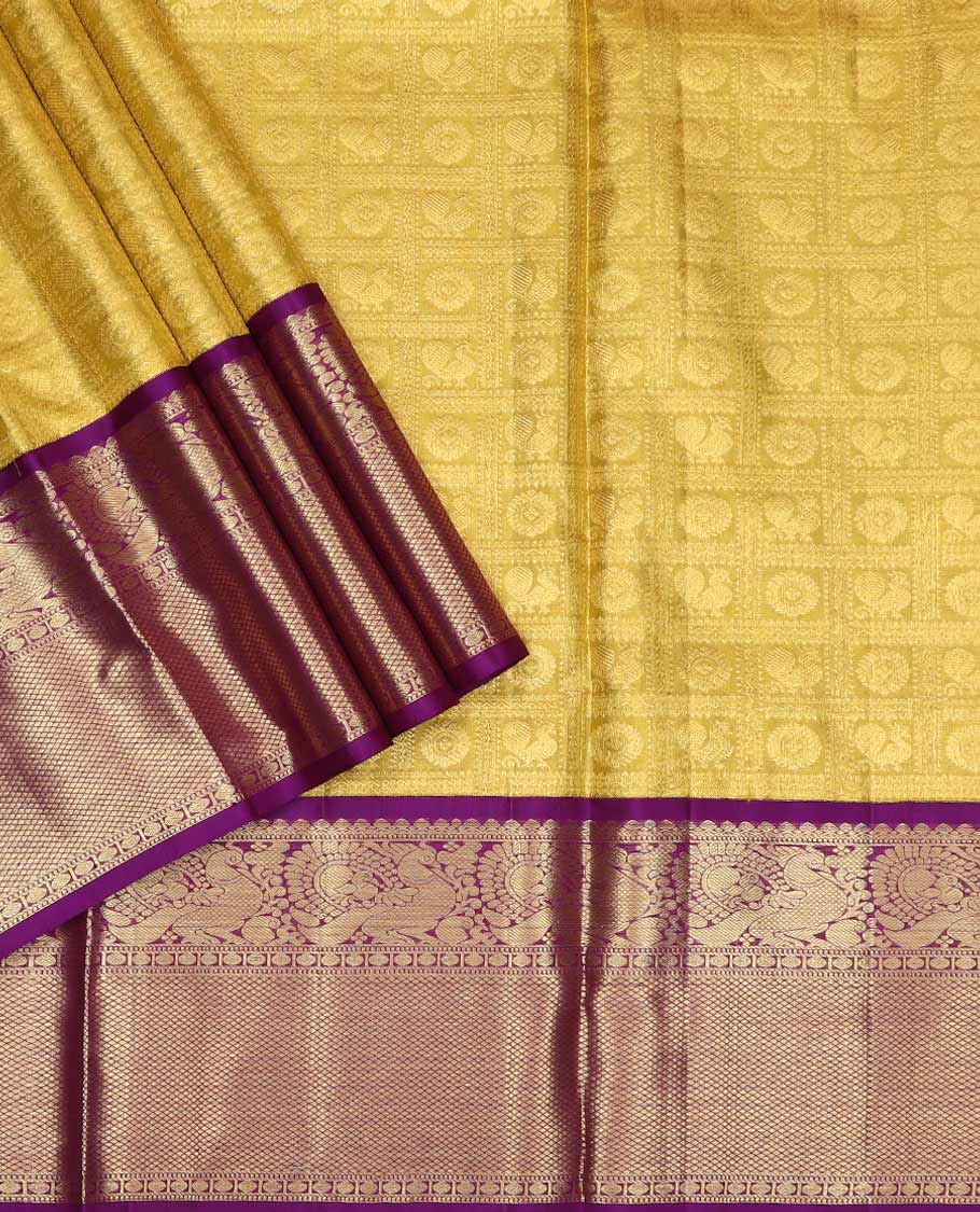 Yellow pure silk half saree, mayil chakram enclosed checked skirt, contrast border of thilakam mokku, muthu, mayil, rudraksham, and mayil kann, jacquard blouse, and zari design dhavani