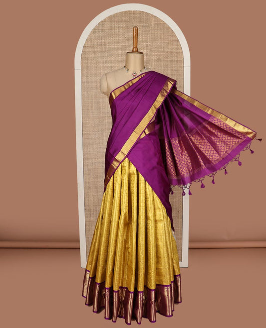 Yellow pure silk half saree, mayil chakram enclosed checked skirt, contrast border of thilakam mokku, muthu, mayil, rudraksham, and mayil kann, jacquard blouse, and zari design dhavani