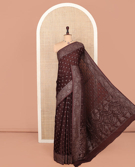 Brown Fancy Crepe Saree, Subtly Sparkled with Buttas, Highlighted by a Floral Creeper Border, Intricate Pallu, and a Matching Blouse