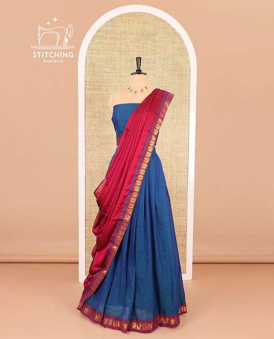Blue half saree, plain with contrast zari peacock motifs bordered skirt, matching blouse and a contrast peacock border dhavani