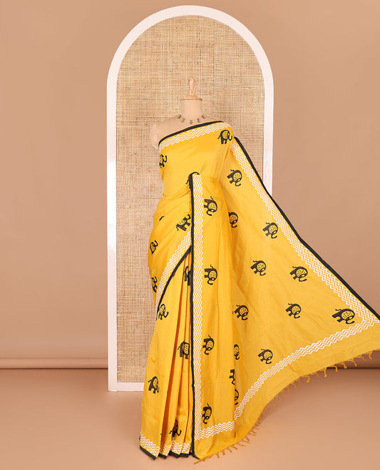 Yellow elephant motifs block printed South cotton saree, chevron stripes block printed border, a matching blouse, and a contrast floral vine printed blouse