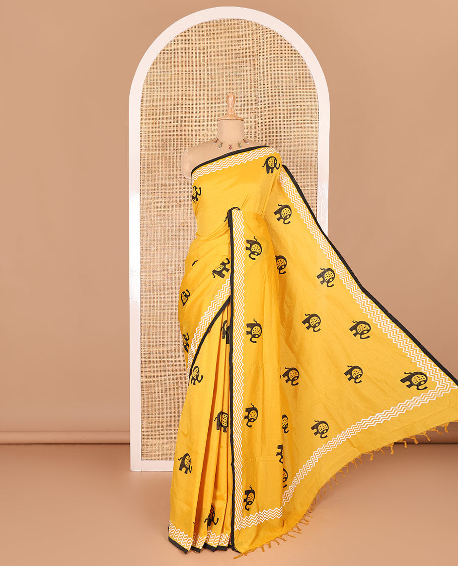 Yellow elephant motifs block printed South cotton saree, chevron stripes block printed border, a matching blouse, and a contrast floral vine printed blouse