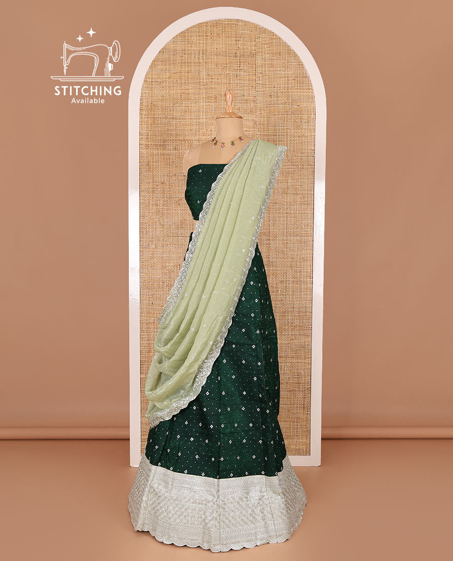 Green half-saree, floral motifs embroidered semi-raw silk top, matching embroidered blouse, and contrast scallop embroidered georgette dhavani