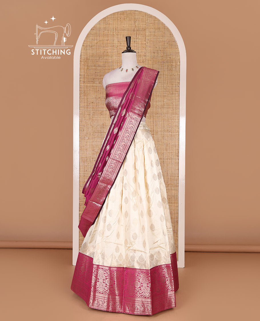 Cream with magenta semi-banarasi half-saree, zari buttas with contrast traditional zari border skirt, zari jacquard blouse, and zari design dhavani