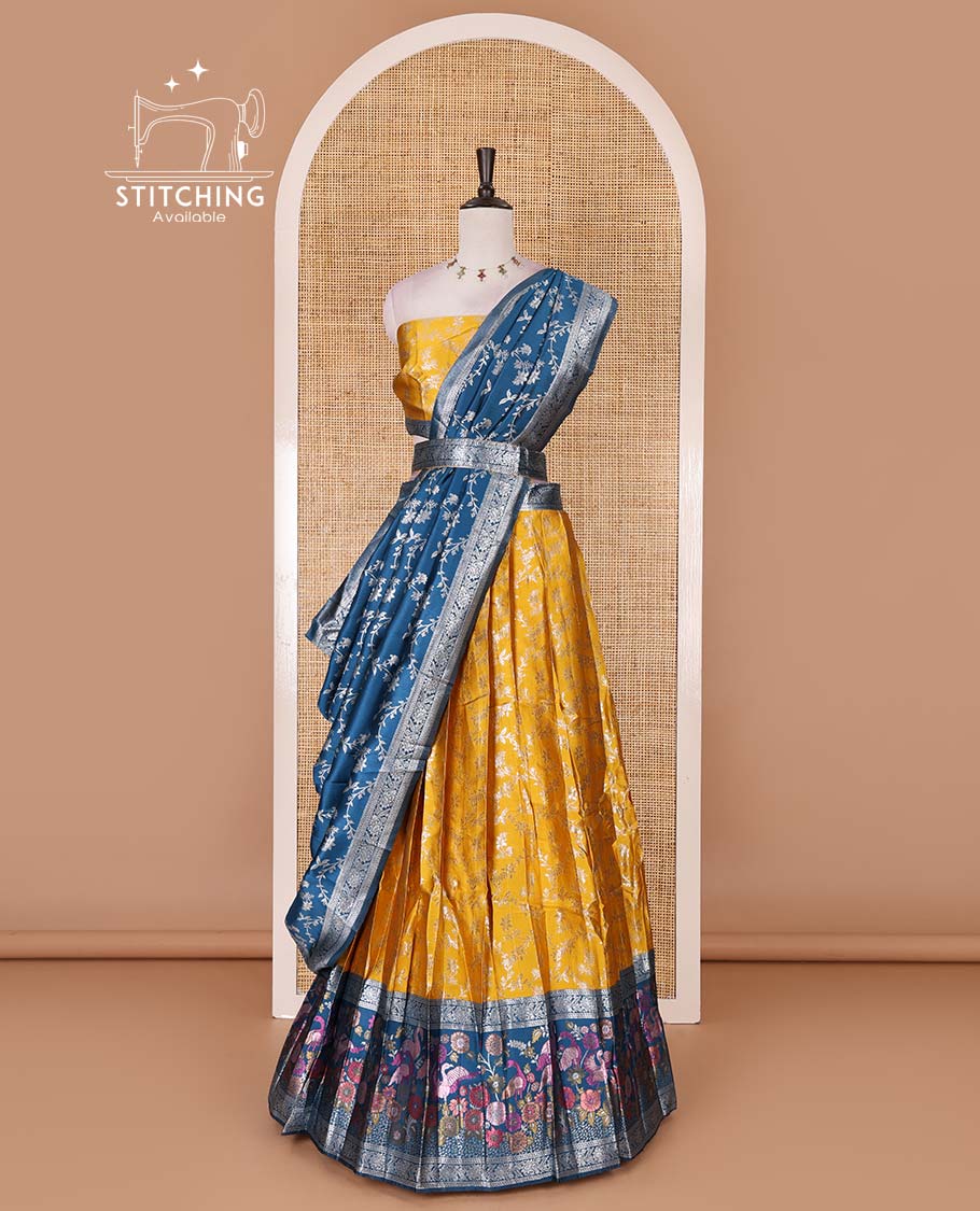 Haldi yellow taffeta silk half saree, floral jaal jacquard skirt, contrast wine zari meenakari style bird border, matching blouse, and floral jaal dhavani