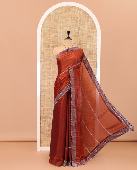 Rust color horizontally swarovski stone striped fendi chiffon saree, swarovski stone work border, and a plain blouse