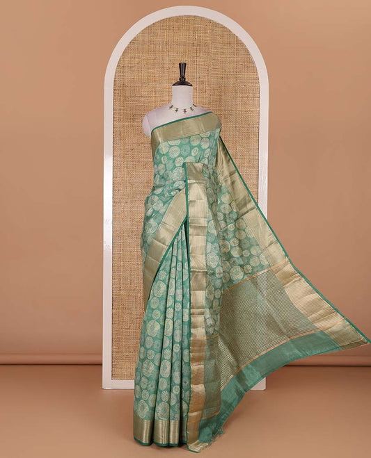 Green uniquely printed semi-tussar saree, traditional zari border, zari striped pallu, and a matching blouse
