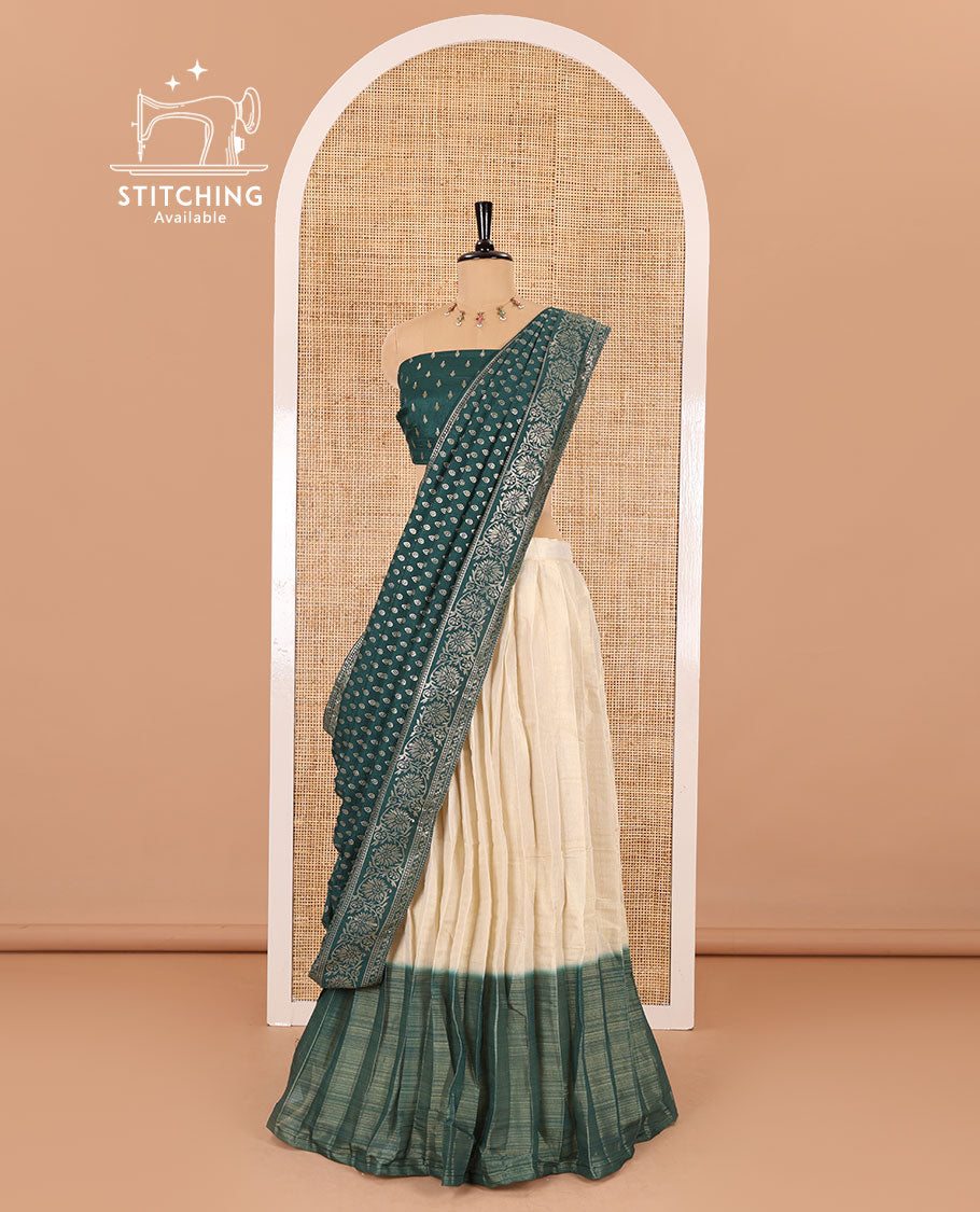 Cream-green Vichitra half-saree, plain and contrast bordered skirt, contrast leaf buttas blouse, dhavani of buttas and floral creeper designs