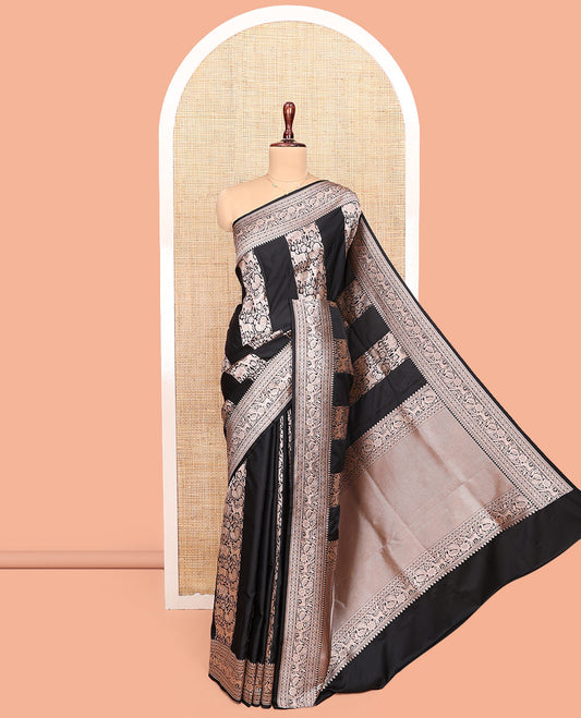 Black Semi-Banaras Silk Saree, Majestically Detailed with Animal-themed Jacquard Designs on Its Body, Highlighted by a Zari Border of Traditional Designs, Pallu Steeped with Stripes, and Paired with a Matching Blouse