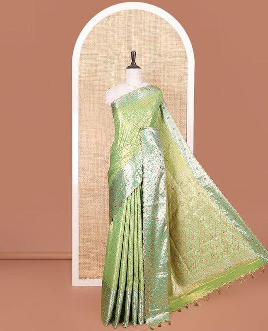 Green Vastrakala Silk Saree Highlighted with Floral Jacquard and Stone Work, Complemented by Contrast Traditional Zari and Stone Embroidered Scallop Border, Pallu Features Jaal Design and Stone Work, and Paired with Contrast Stone Embroidered Blouse