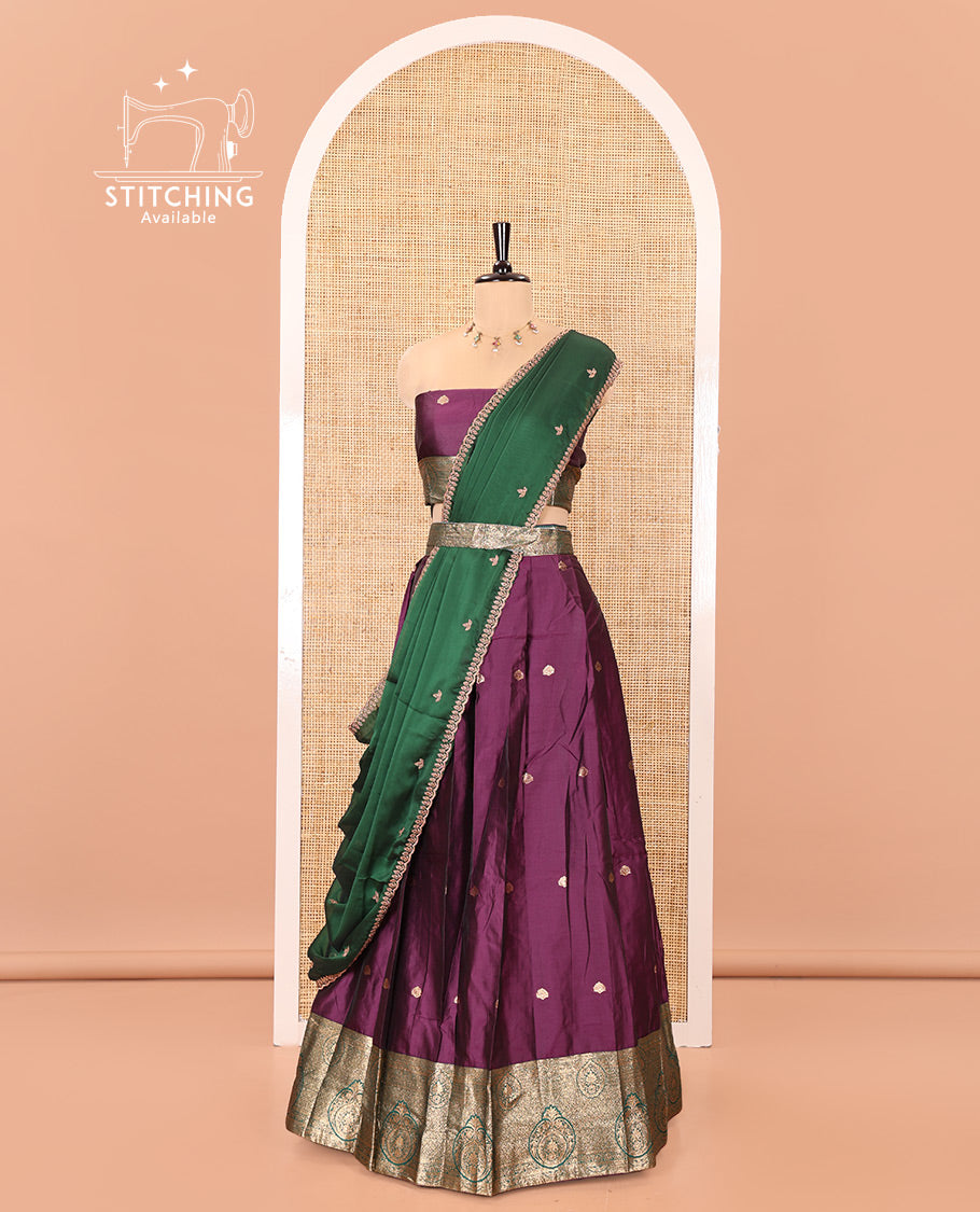 Purple and Green Semi-Banarasi Half-Saree, Entralled with Zari Buttas on Its Skirt, Complemented by a Contrast Intricately Zari-Designed Border, Paired with a Matching Blouse, and a Contrast Satin Georgette Embroidered Scallop Dhavani