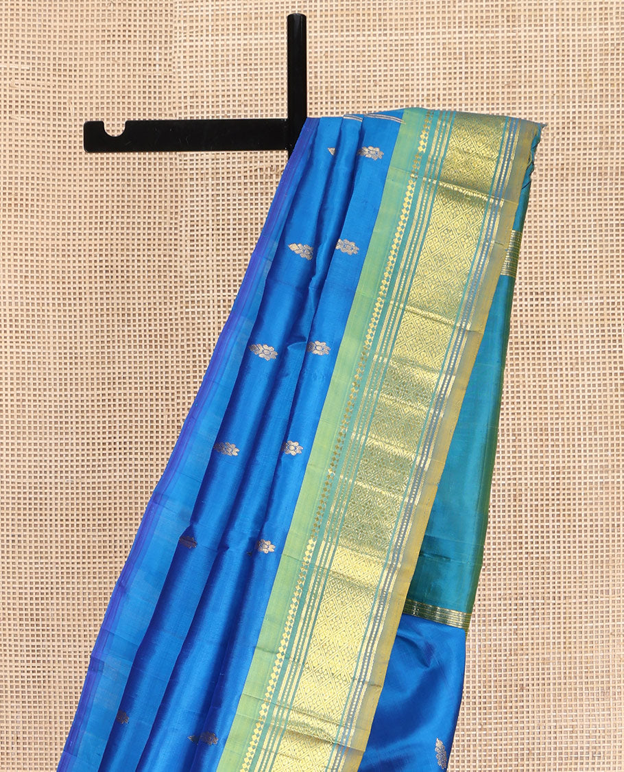 Blue Kanchipuram Silk Saree, Spotlighted with Zari Buttas on Its Body, Complemented by Contrast One-Sided Border of Panner Sombu, Banaras, Muthu, and Jaal Designs, Pallu Features Zari Designs, and Comes Without a Blouse