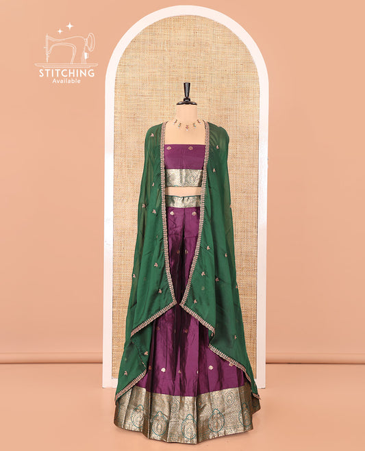 Purple and Green Semi-Banarasi Half-Saree, Entralled with Zari Buttas on Its Skirt, Complemented by a Contrast Intricately Zari-Designed Border, Paired with a Matching Blouse, and a Contrast Satin Georgette Embroidered Scallop Dhavani