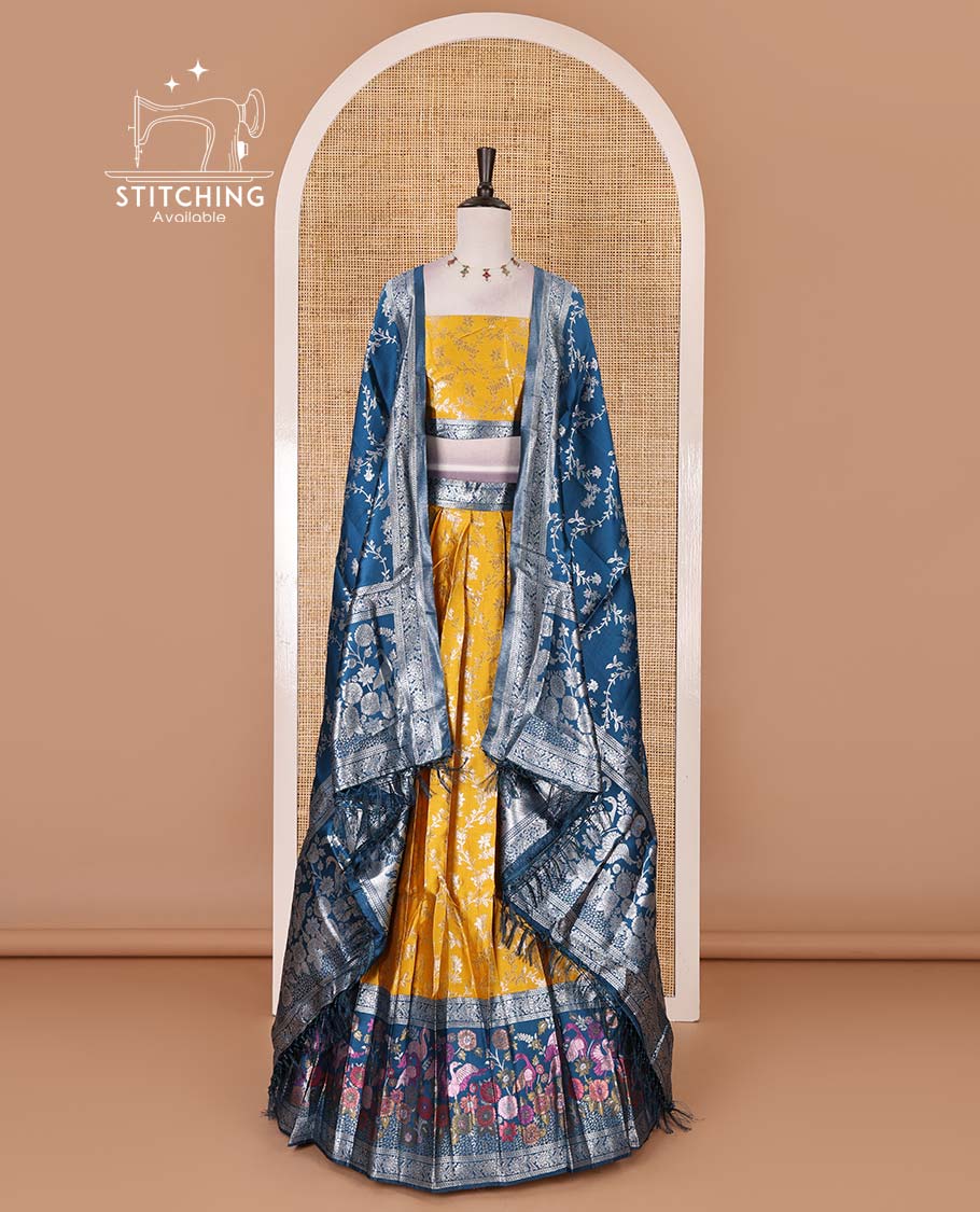 Haldi yellow taffeta silk half saree, floral jaal jacquard skirt, contrast wine zari meenakari style bird border, matching blouse, and floral jaal dhavani