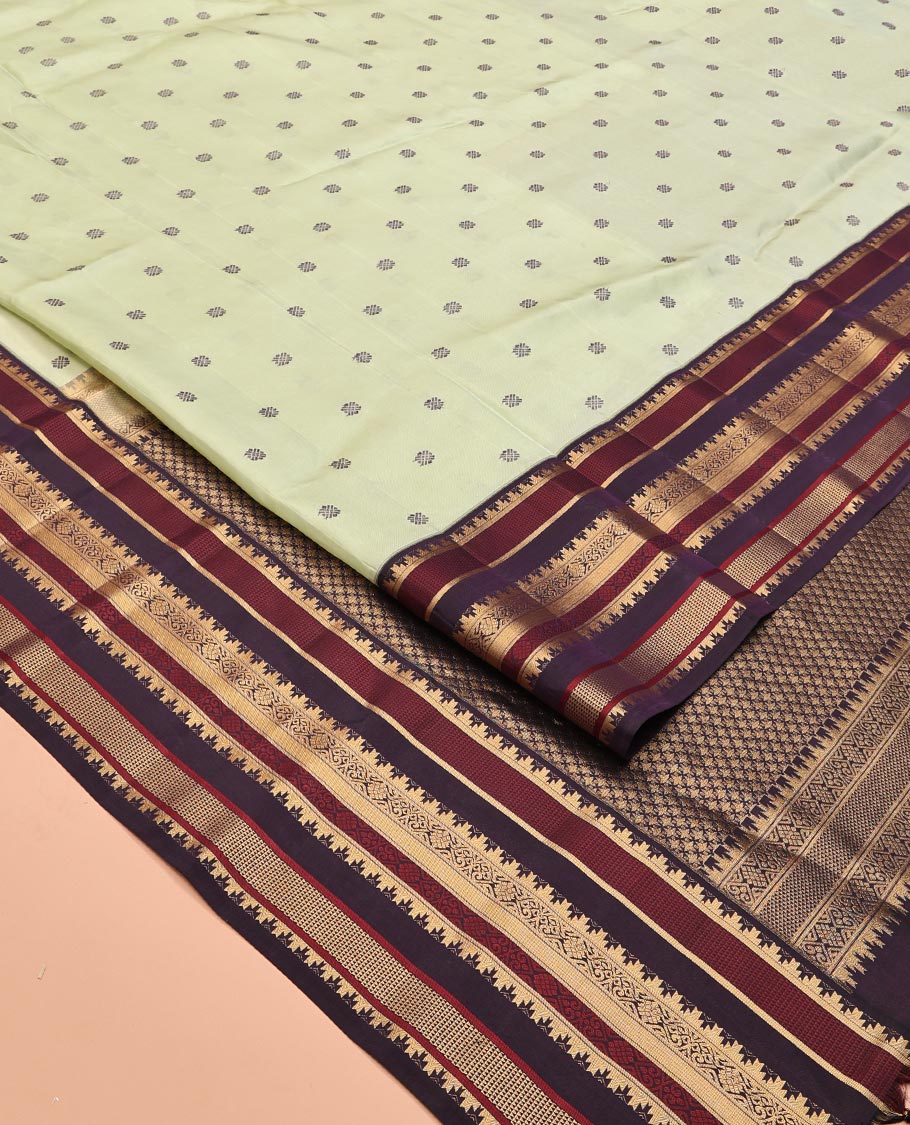 Pista Green and Coffee Brown Vasundenhara Lite Silk Mix Saree, Subtly Adorned with Buttas All Over Its Body, Complemted by Contrast Border of Thazampoo Rekku, Banaras, Jada Nagam, and Ara Maadam Designs, Grand Pallu, and Paired with a Contrast Blouse