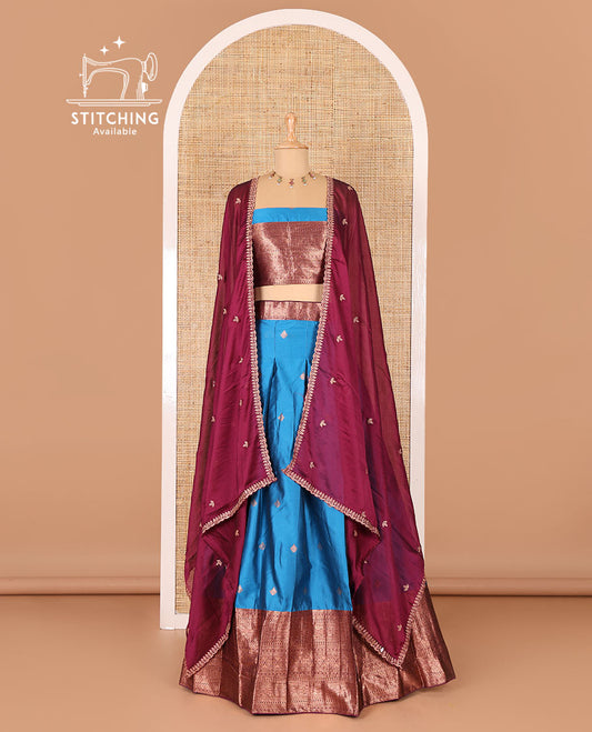 Blue taffeta silk half-saree, zari buttas and contrast traditional zari bordered skirt, a matching blouse, and contrast embroidered satin georgette  dhavani